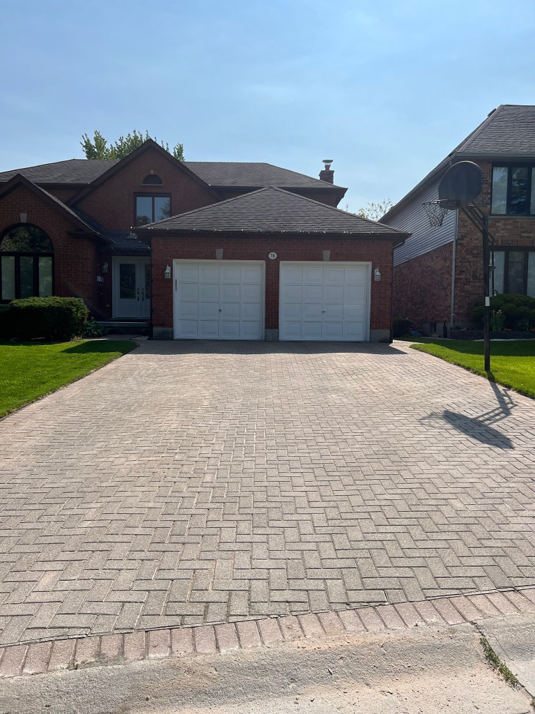 Clean concrete driveway in Oakridge London Ontario after professional pressure washing by Core Exteriors